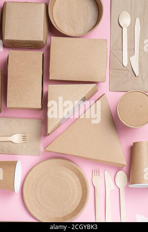 Stack of eco paper food containers placed closely together over pink background Stock Photo