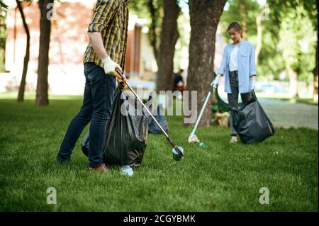 Two men collects plastic garbage, volunteering Stock Photo
