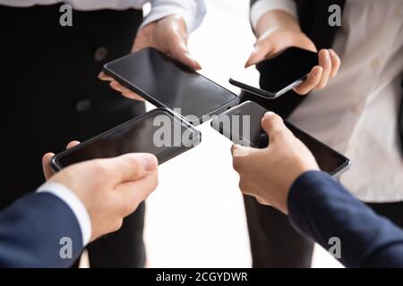 Close up of diverse businesspeople using smartphones Stock Photo