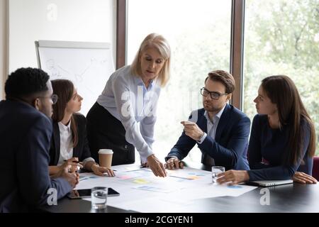 Motivated diverse businesspeople brainstorm at team meeting Stock Photo