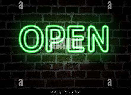 OPEN - neon light entrance sign on brick wall Stock Photo
