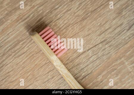 Eco-friendly bamboo toothbrush on a table. Zero-waste. Biodegradable toothbrush. Stock Photo