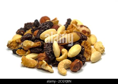 A mix of nuts and raisins against a white background Stock Photo
