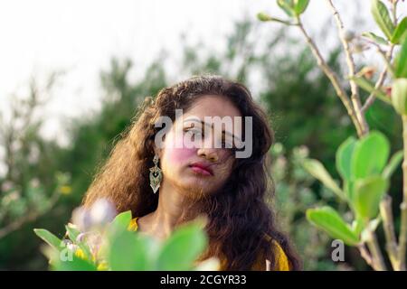 A beautiful Asian woman faces open hair with selective focus points background, outdoors closeup portrait Stock Photo