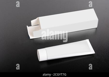 Rectangular box package mockup with tube on ground, editable mock-up series template ready for your design, faces selection path included. Stock Photo