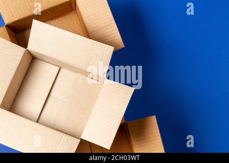 Empty open cardboard boxes on blue background. Top view Stock Photo