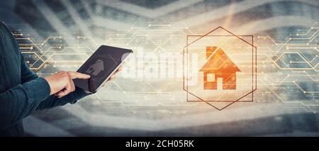 Working and studying from home conceptual background. Close up person hands using tablet computer gadget, press the PC screen to display a digital hou Stock Photo
