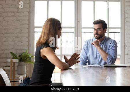 Focused business partners negotiate at meeting in office Stock Photo