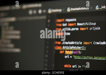 New york, USA - September 13, 2020: Colorful program code in black background on computer screen close up view Stock Photo
