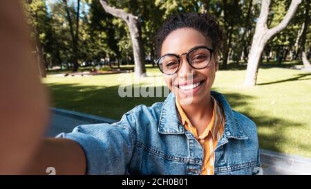 Cheerful African American Girl Making Selfie Standing In Park, Panorama Stock Photo