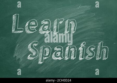 Hand drawing 'Learn Spanish' on green chalkboard Stock Photo