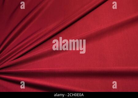 Red bright knitwear. Draped fabric with pleats, jersey, can be used as background Stock Photo