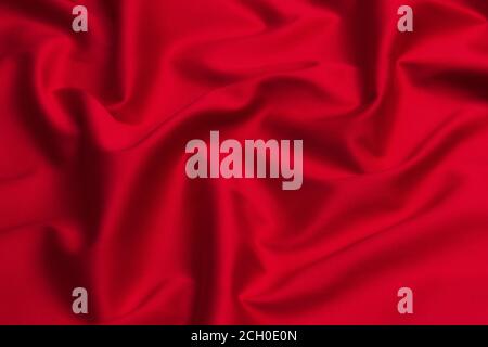 Red silk or satin luxury fabric texture can use as abstract background. Top view. Stock Photo