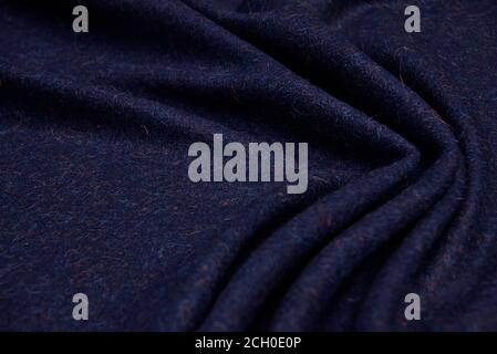 Dark blue wool for coat. Close up texture of the fabric is useful as a background. Stock Photo