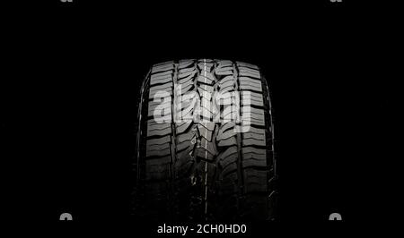 tire for SUVs and crossovers with powerful checkers and grapples close-up on a black background Stock Photo