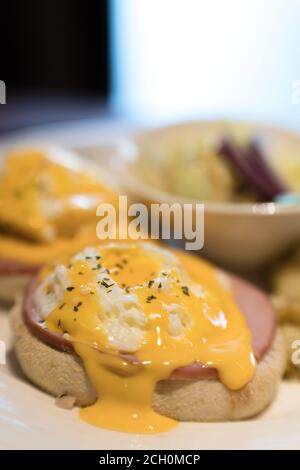 Weekend vegetarian breakfast in Scotland with two eggs benedict on homemade muffins with spinach and yellow hollandaise sauce. Stock Photo