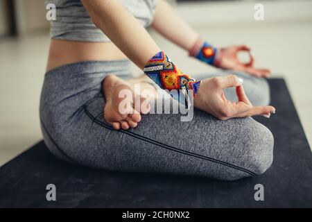 Group of young sporty people practicing yoga lesson with instructor, sitting in vajrasana pose, working out, indoor full length, students training in Stock Photo