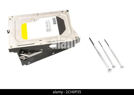 Repairing hard drive in service center HDD recovery. Data storage. Recover lost data. Screwdriver near he hard drive. On white background. isolated Stock Photo