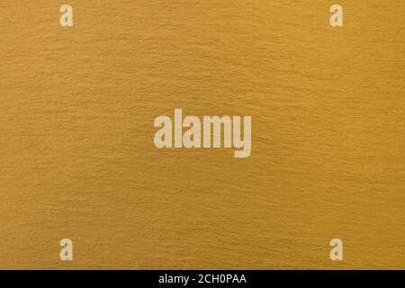 golden background, gold brown mustard color, natural stone, horizontal banner Stock Photo