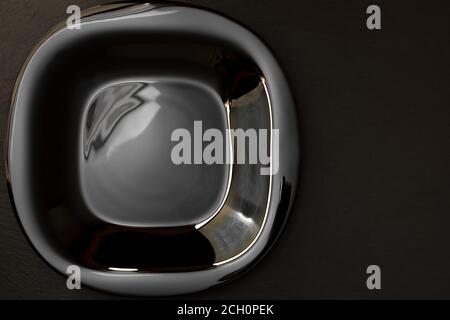 Empty black plate on dark moody black background with copy space. Top view of black plate on gray table Stock Photo