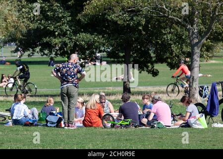 London, UK. 13 Sept 2020: Londoners took advantage of sunny weather on Clapham Common the day before social distancing rules will change. From tomorrow this multi-family picnic would be illegal. Anna Watson/Alamy Live news Stock Photo