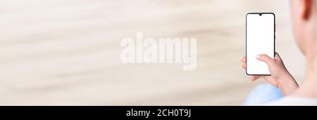 Woman's Hand Holding Cell Phone With Blank Screen, female hand holding a phone, mockup, banner Stock Photo