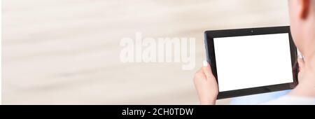 Woman sitting and holding blank screen mock up tablet. Hand Holding tablet With Blank Screen, banner Stock Photo