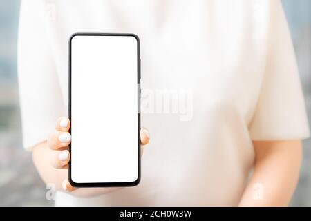 woman hands holding smart phone with blank copy space screen, Women hold or show smartphones ahead, mockup Stock Photo