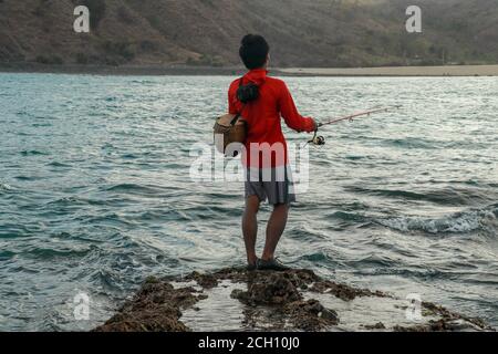 Indonesian fishermen with fishing rods on the beach at Sanur, Bali,  Indonesia Stock Photo - Alamy