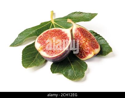 Half and quarter of a fresh ripe sweet fig fruit on a green fig leaf isolated on a white background. Design element for vegetarian, raw food diet. Stock Photo