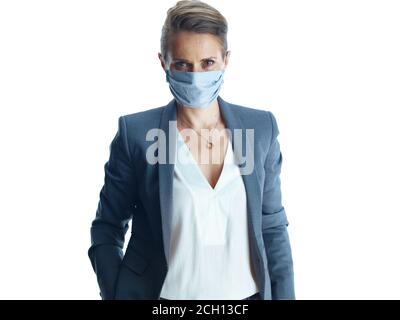 Business during coronavirus pandemic. Portrait of elegant female in a grey suit with medical mask isolated on white. Stock Photo