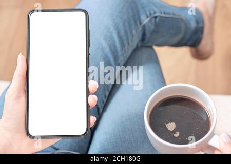 Cell phone mockup. Image blank white screen. Woman hand holding texting using mobile at coffee shop. empty space for advertise text. people contact ma Stock Photo