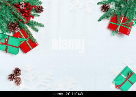 Christmas or winter composition. Frame made of snowflakes, Christmas gift, pine cones, fir branches, christmas light, garland on pastel blue backgroun Stock Photo