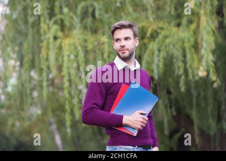 college student guy study with notebook outdoor preparing for exam and graduation, education. Stock Photo
