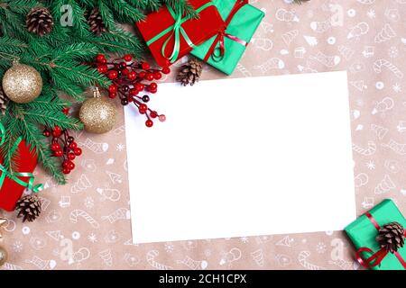 Christmas letter. Christmas greeting card. Empty wishlist for Santa Claus. Gift, postcard, pine cones, fir branches on white textured table. Christmas Stock Photo
