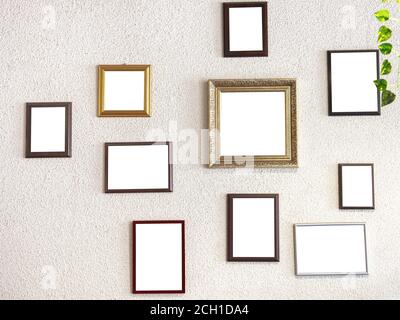 mockup image. different size picture framed hanging on the gray wall. Blank of wooden frames picture hanging on concrete wall background. Various fram Stock Photo