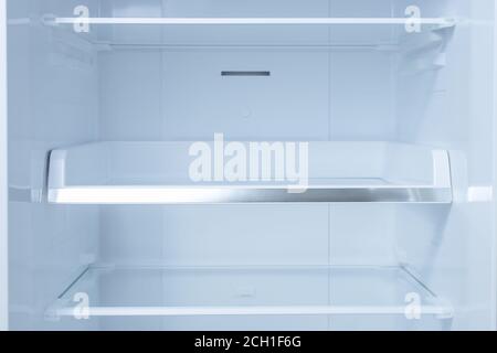 Inside of clean and empty refrigerator with shelves. background for health or diet concept. empty shelves for your products Stock Photo