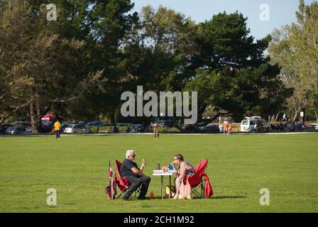 Poole, UK. 13th September 2020. Table for two - Relaxing in the warm September sunshine in Baiter Park in Poole, Dorset. credit: Richard Crease/Alamy Live News Stock Photo