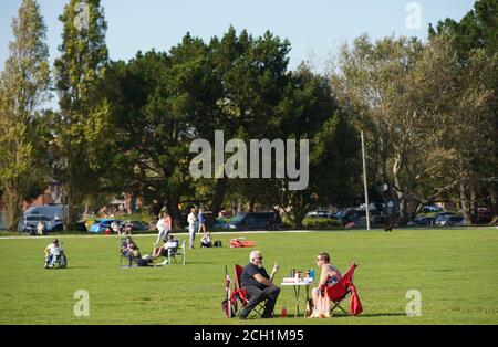 Poole, UK. 13th September 2020. Table for two - Relaxing in the warm September sunshine in Baiter Park in Poole, Dorset. credit: Richard Crease/Alamy Live News Stock Photo