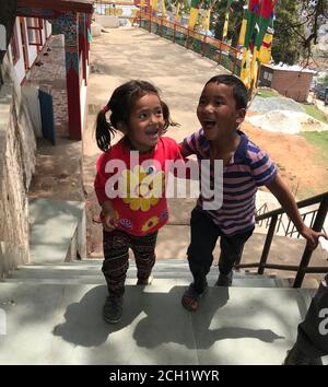 Cute smiling nepalese children. Laughing funny kids. Little friends, boy and girl from Kathmandu, Nepal. Happiness. Child smile. Glad nepali kids. Stock Photo