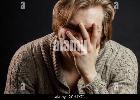 Oh, my God. oops. whoops.close up portrait of embarrassed guy isolated on the black background Stock Photo