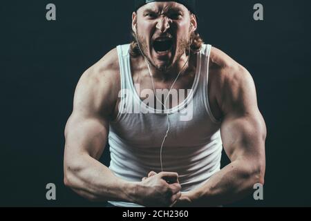 angry professional bodybuilder taking part in the competition, close up cropped photo Stock Photo