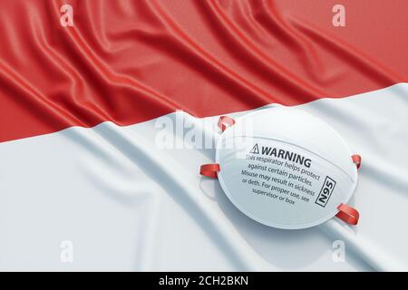Coronavirus medical surgical face mask on the Indonesian national flag. Illness, pandemic, virus covid-19 in Indonesia, concept 3d rendering illustrat Stock Photo