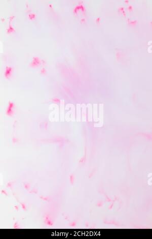 Fluid art texture. White pink background from liquid. Photography of colored spots on liquid. Abstract pattern for design Stock Photo