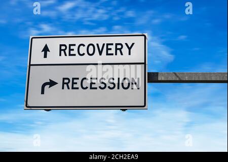 Road sign with words recovery and recession. White two street signs with arrow on metal pole. Stock Photo