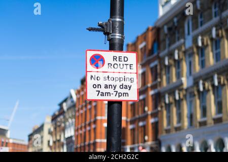 Red route no stopping sign on a post. London Stock Photo