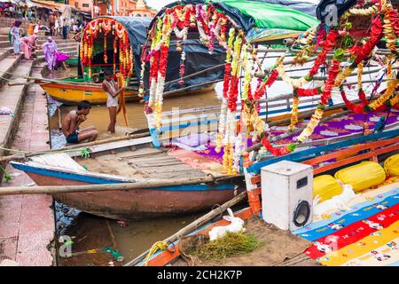 Chitrakoot, Madhya Pradesh, India : Colourful boats lining along the steps of Ramghat. Incidental people in background. Stock Photo