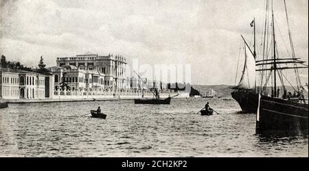 A historical exterior view of the Turkish imperial Dolmabahçe Palace, Constantinople, Turkey, as seen from the Bosporus, taken from a postcard c.1900-1910. Stock Photo