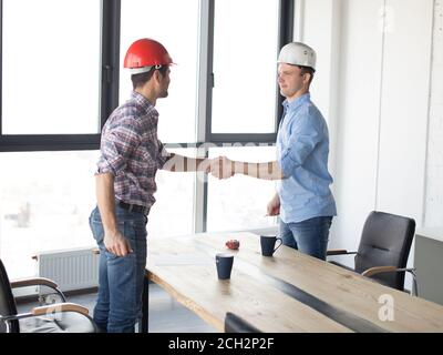 two engineers are greeting each other in the break time agreement concept. side view photo Stock Photo