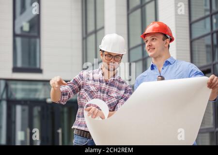 ambitious engineer teamwork are talking about a building plan on the street. business concept Stock Photo